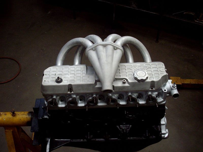A close up of a car engine on a stand