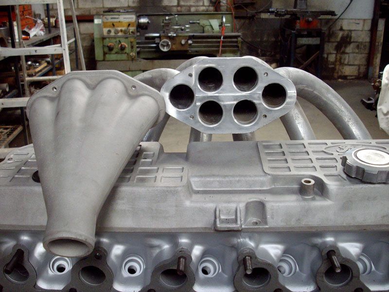 A close up of a car engine in a garage