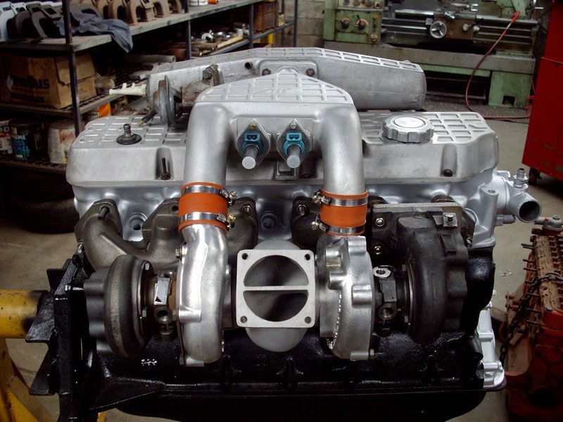 A close up of a car engine in a garage