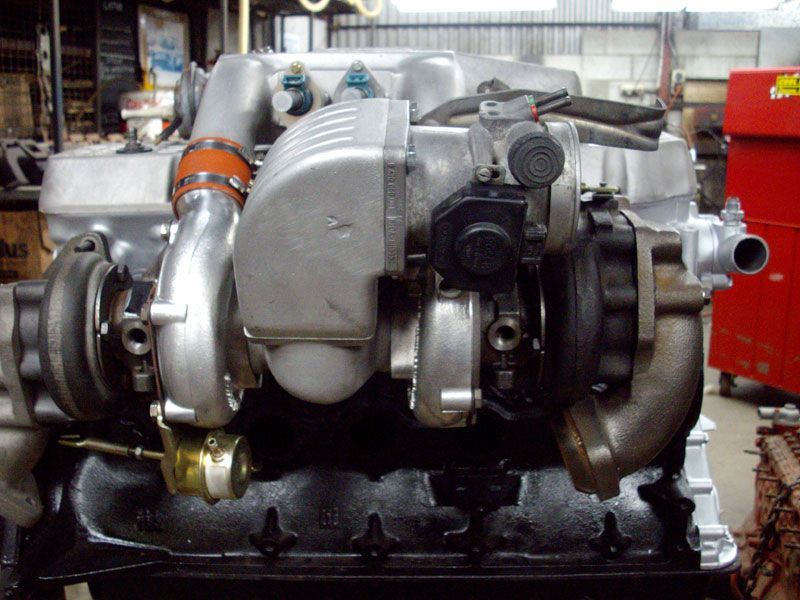 A close up of a car engine in a garage