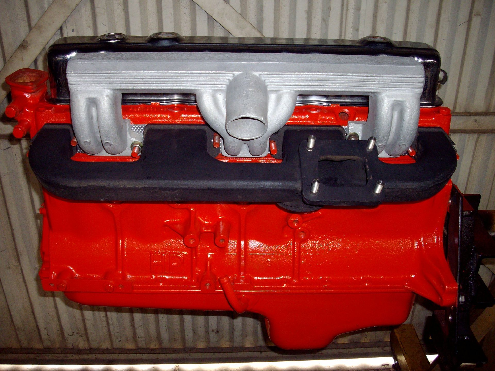 A red and black engine is hanging from the ceiling