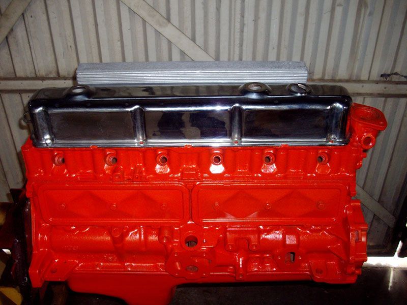 A red engine with a chrome cover on top of it