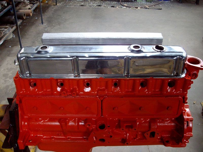 A red engine with a chrome cover on it