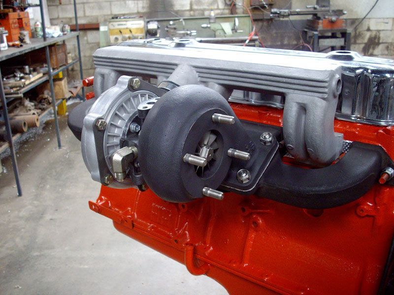 A red engine with a turbocharger attached to it