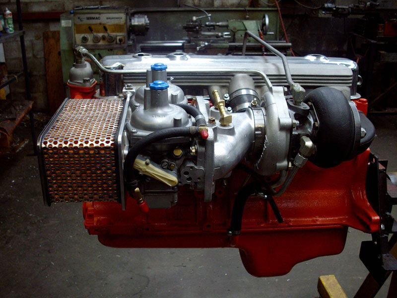 A red and silver engine is sitting on a table