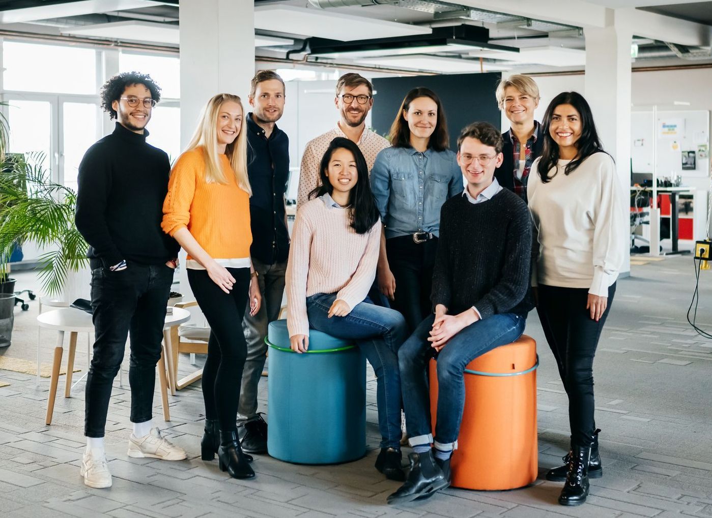 A group of people are posing for a picture in an office.