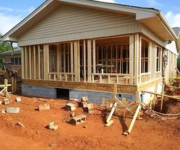 A house that is being built in the dirt