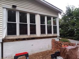 A house with a lot of windows is being remodeled.