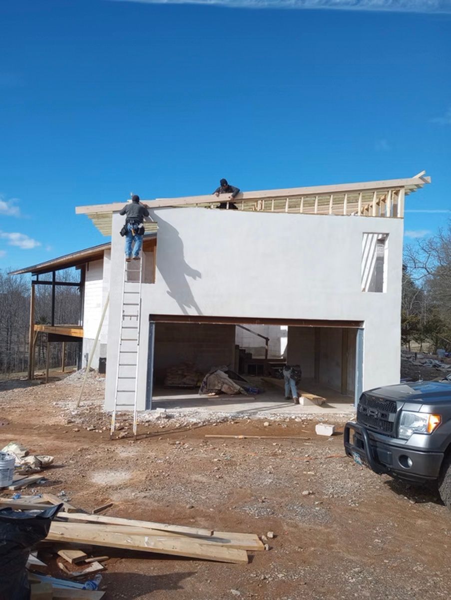 A truck is parked in front of a building under construction