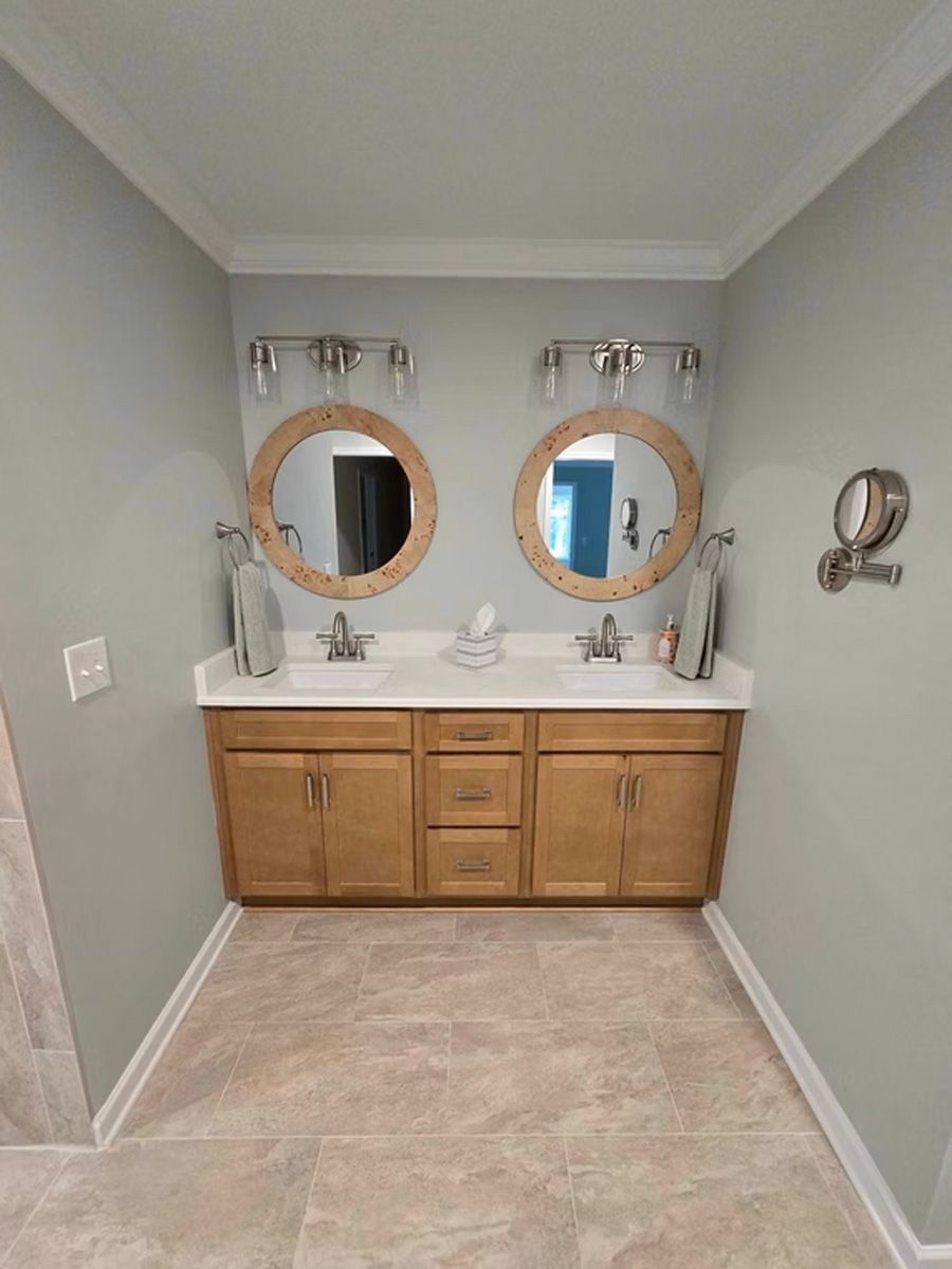 A bathroom with two sinks and two mirrors.