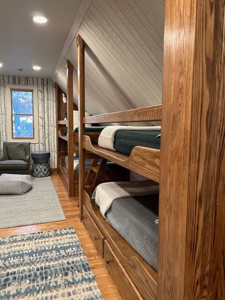 A room with bunk beds and a rug in it.