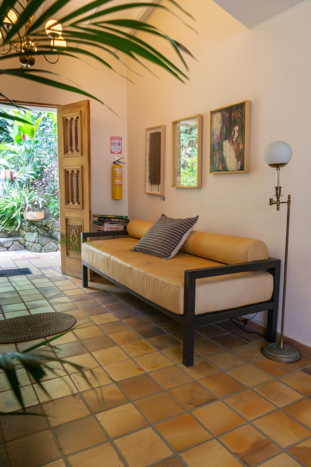 A living room with a couch and a lamp.