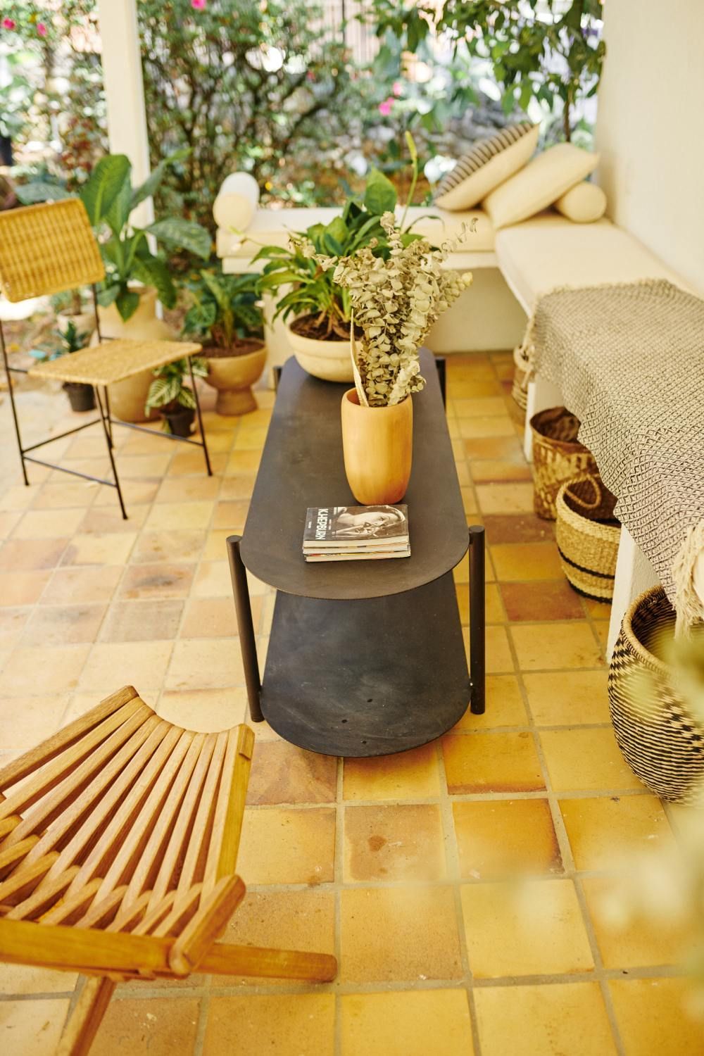 There is a table with a book on it in the middle of the room.