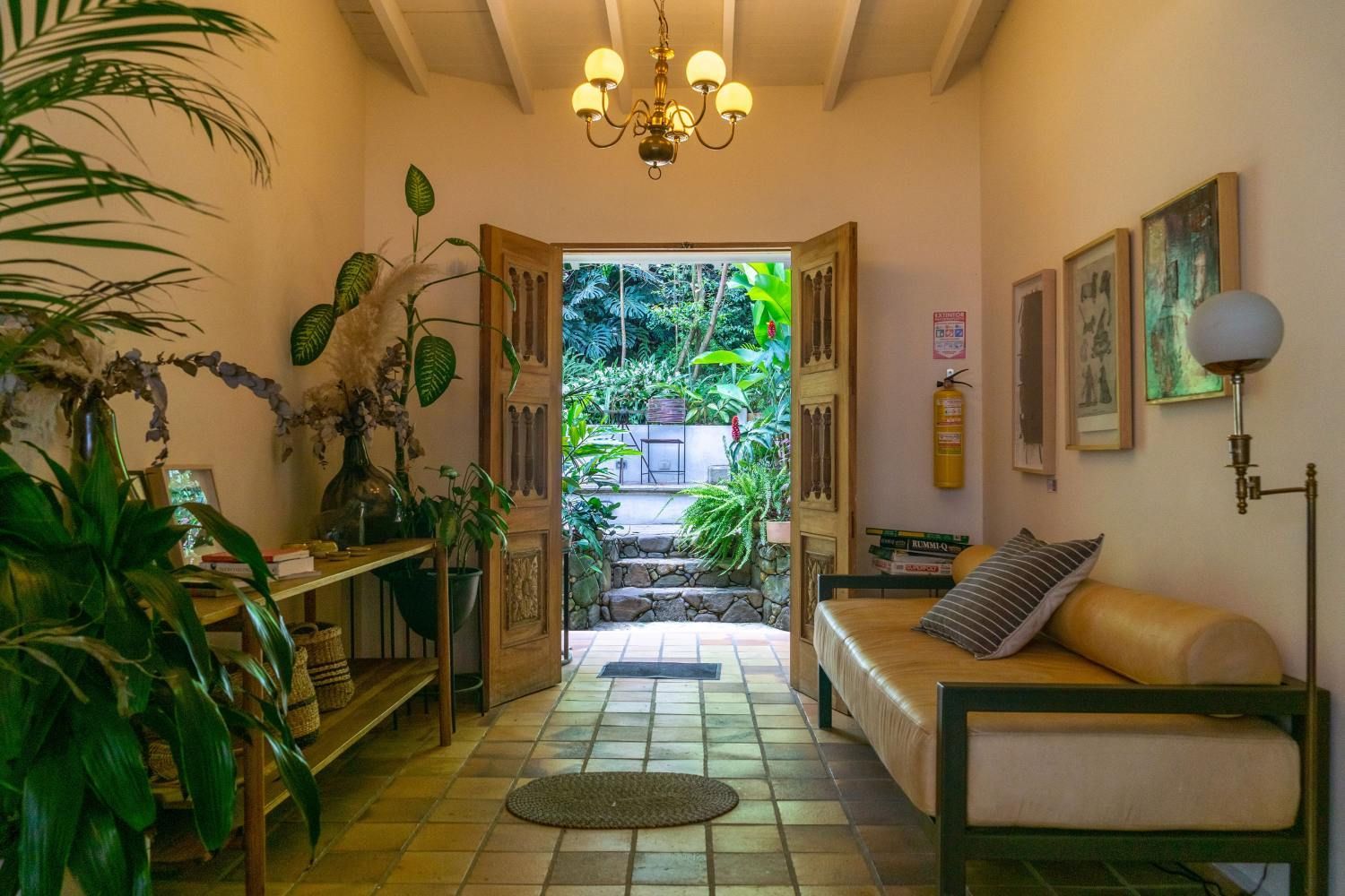 A living room with a couch and a chandelier.