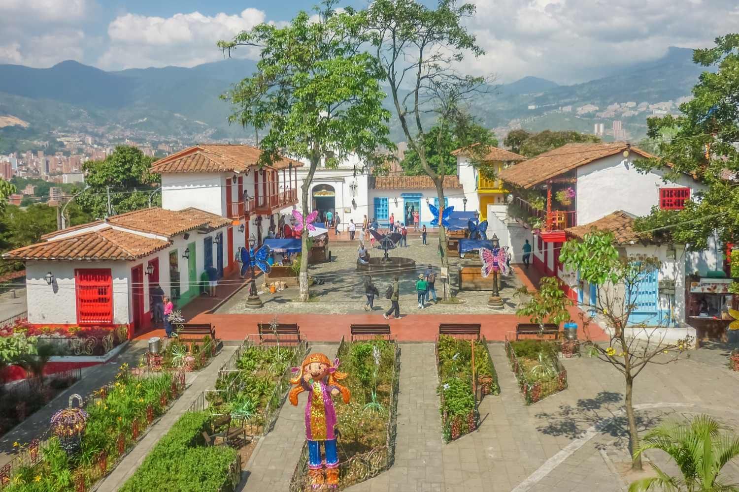 An aerial view of a park with a statue in the middle of it.