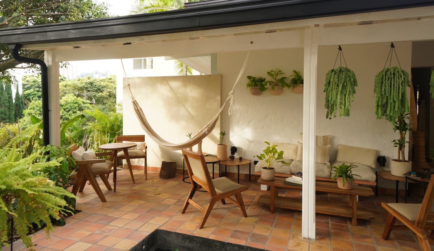There is a hammock on the porch of a house.