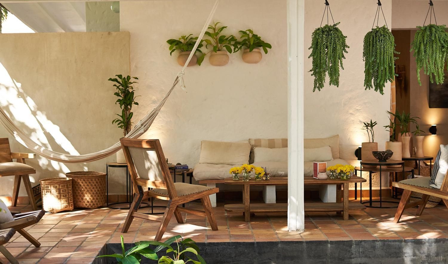 A living room with a hammock hanging from the ceiling