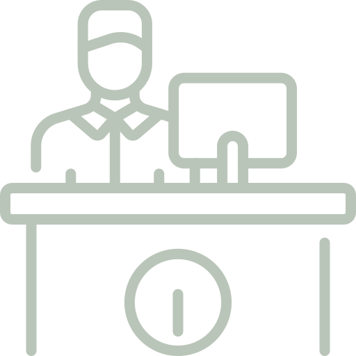 A man is sitting at a desk with a computer on it.