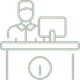 A man is sitting at a desk with a computer on it.