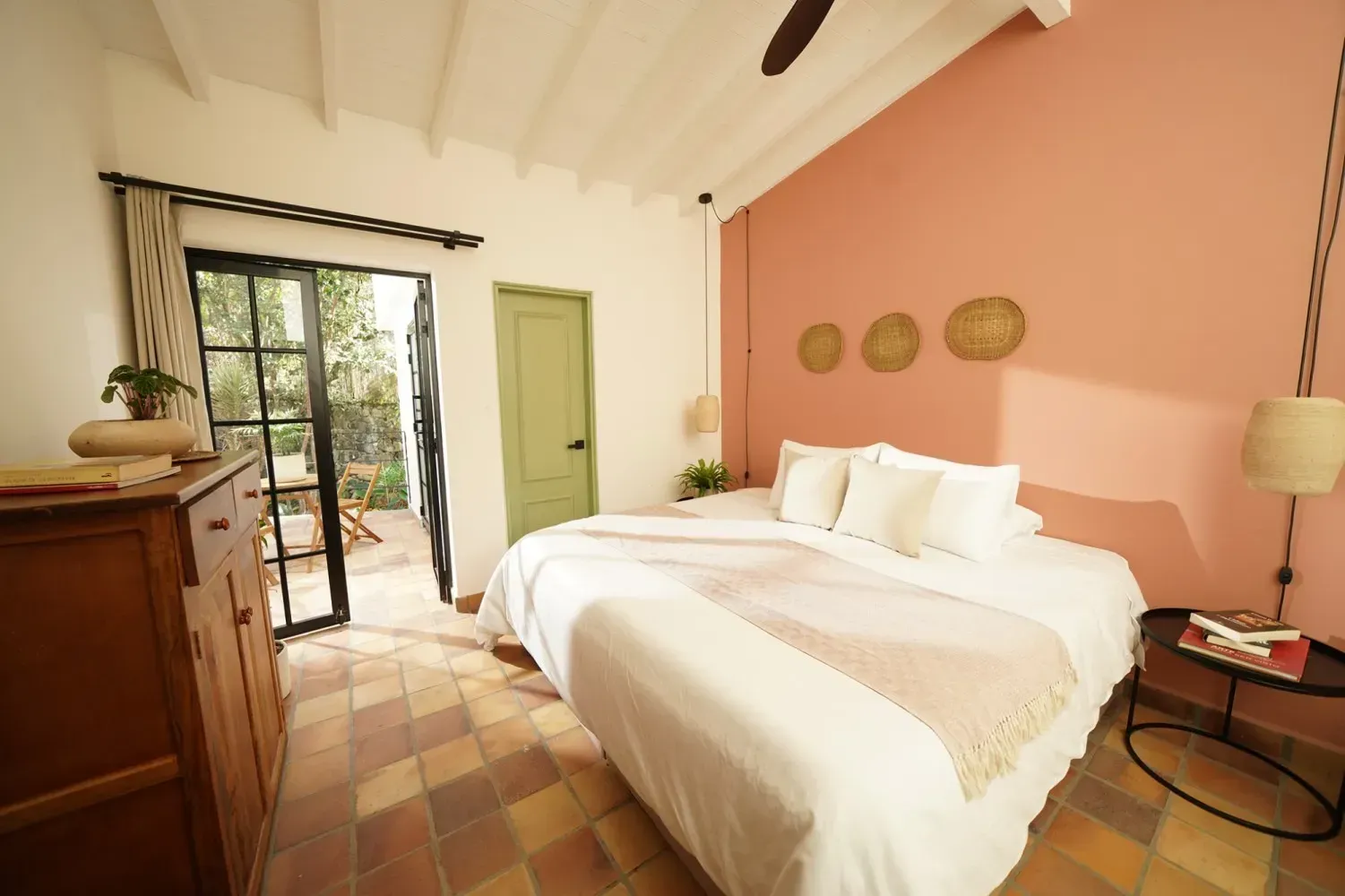 A bedroom with a king size bed and a dresser