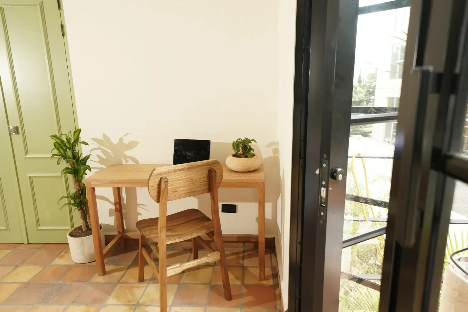 There is a desk with a chair and a laptop on it.