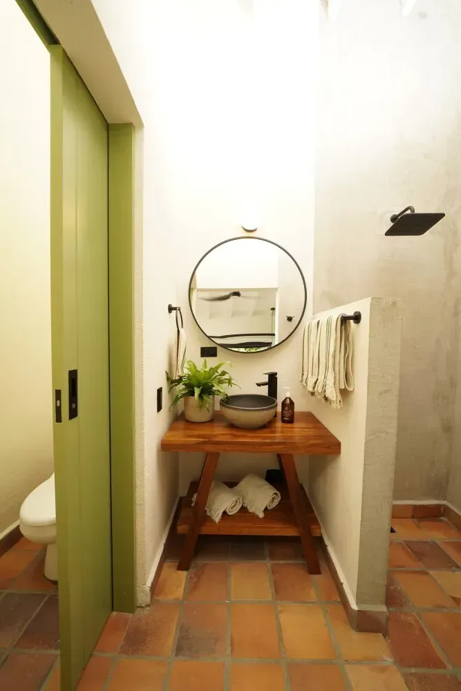 A bathroom with a sink , mirror and toilet