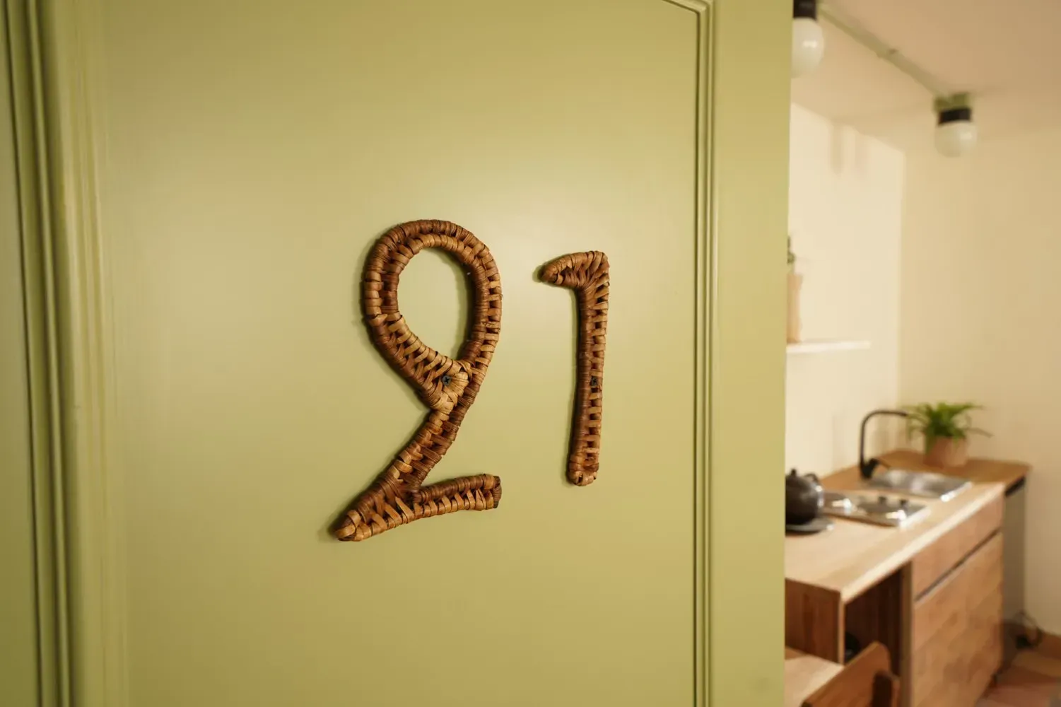 A green door with the number 21 on it