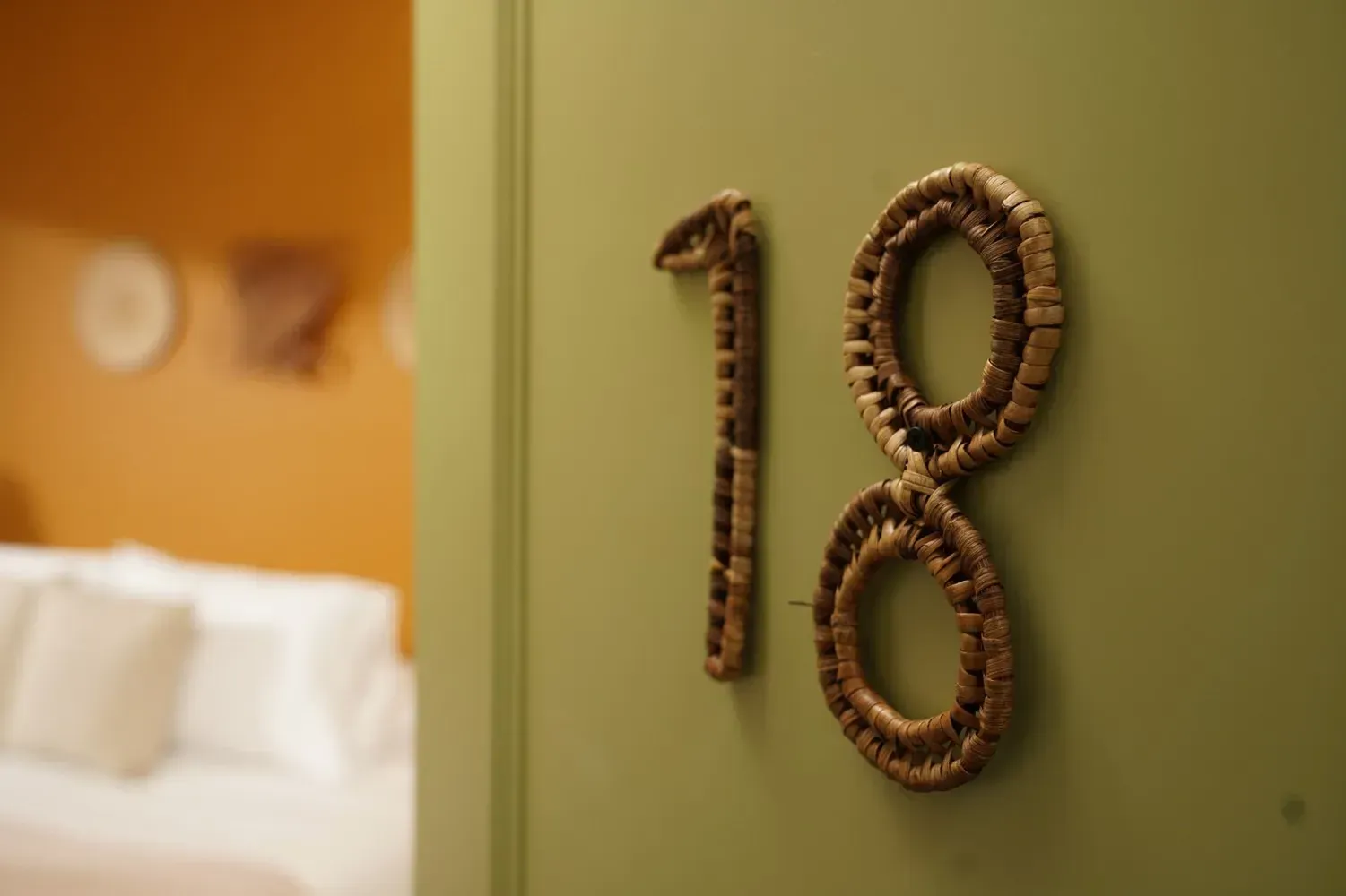 A green door with the number 18 on it