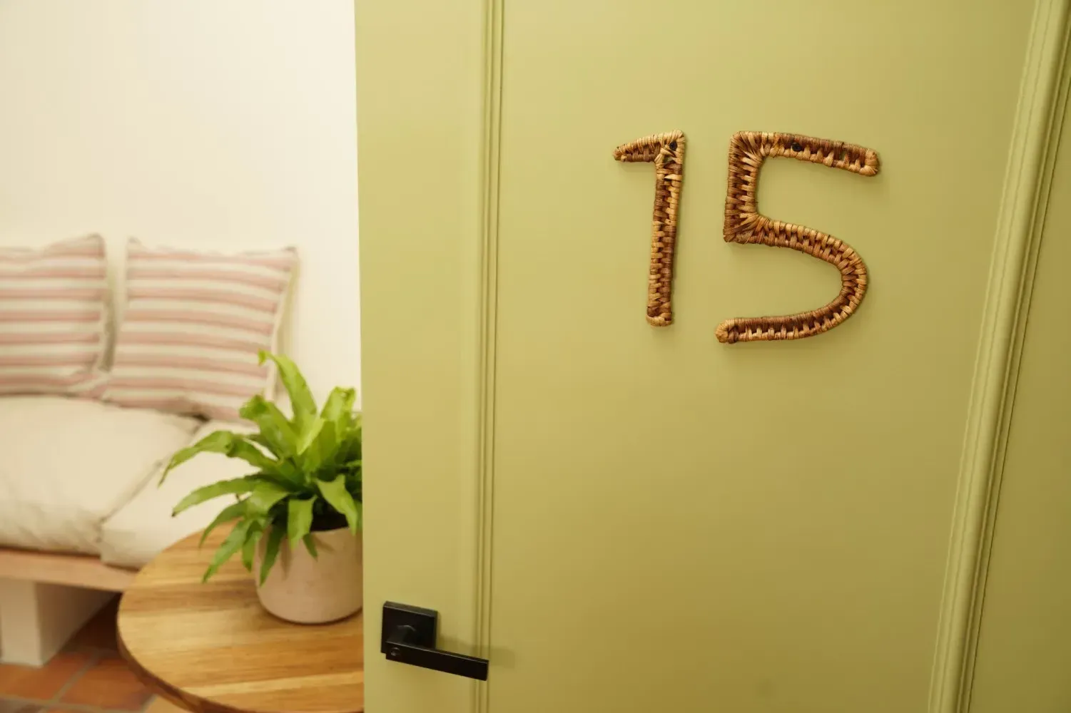 A green door with the number 15 on it