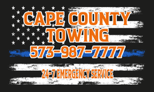 Cape County Towing logo: Orange text on an American flag design with a blue line, phone number 573-987-7777, and 24/7 emergency service.