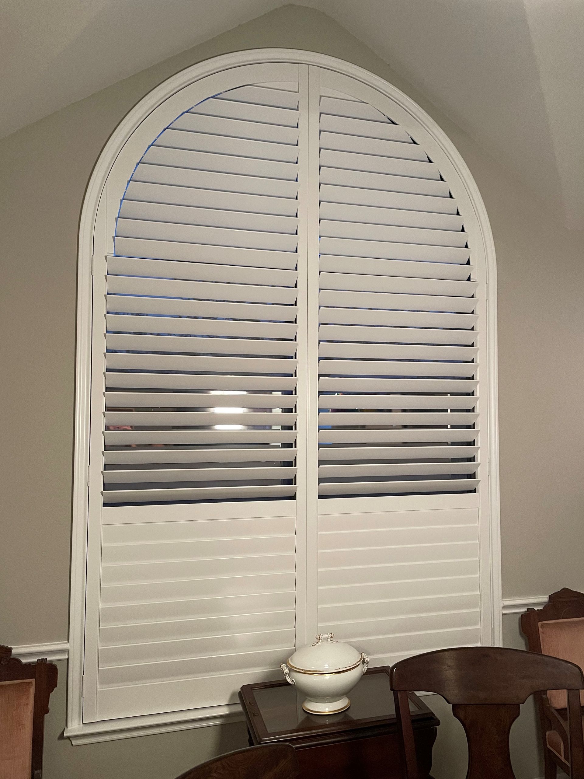 West lake hallway features arched plantation shutters over doors