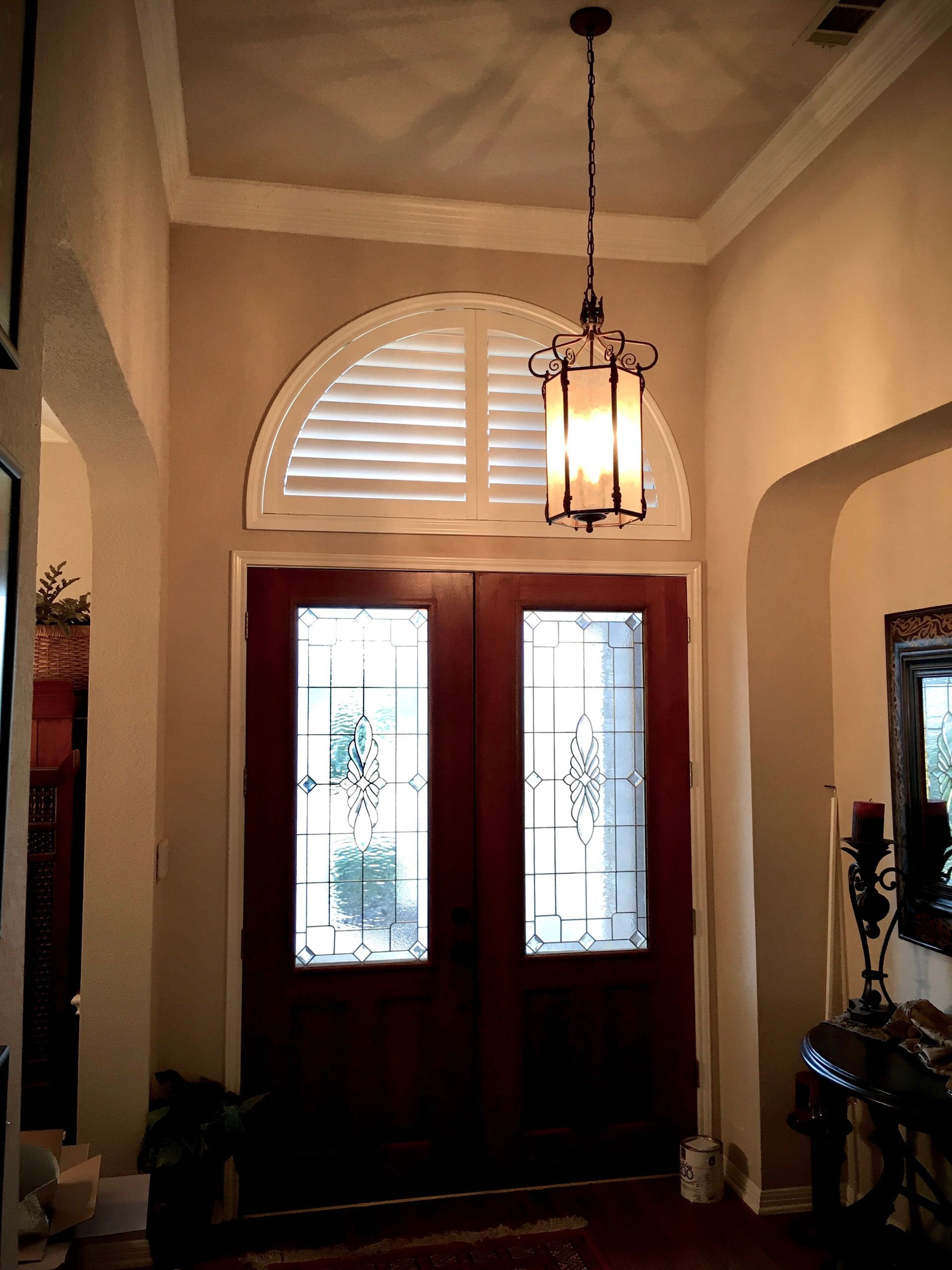 West lake hallway features arched plantation shutters over doors