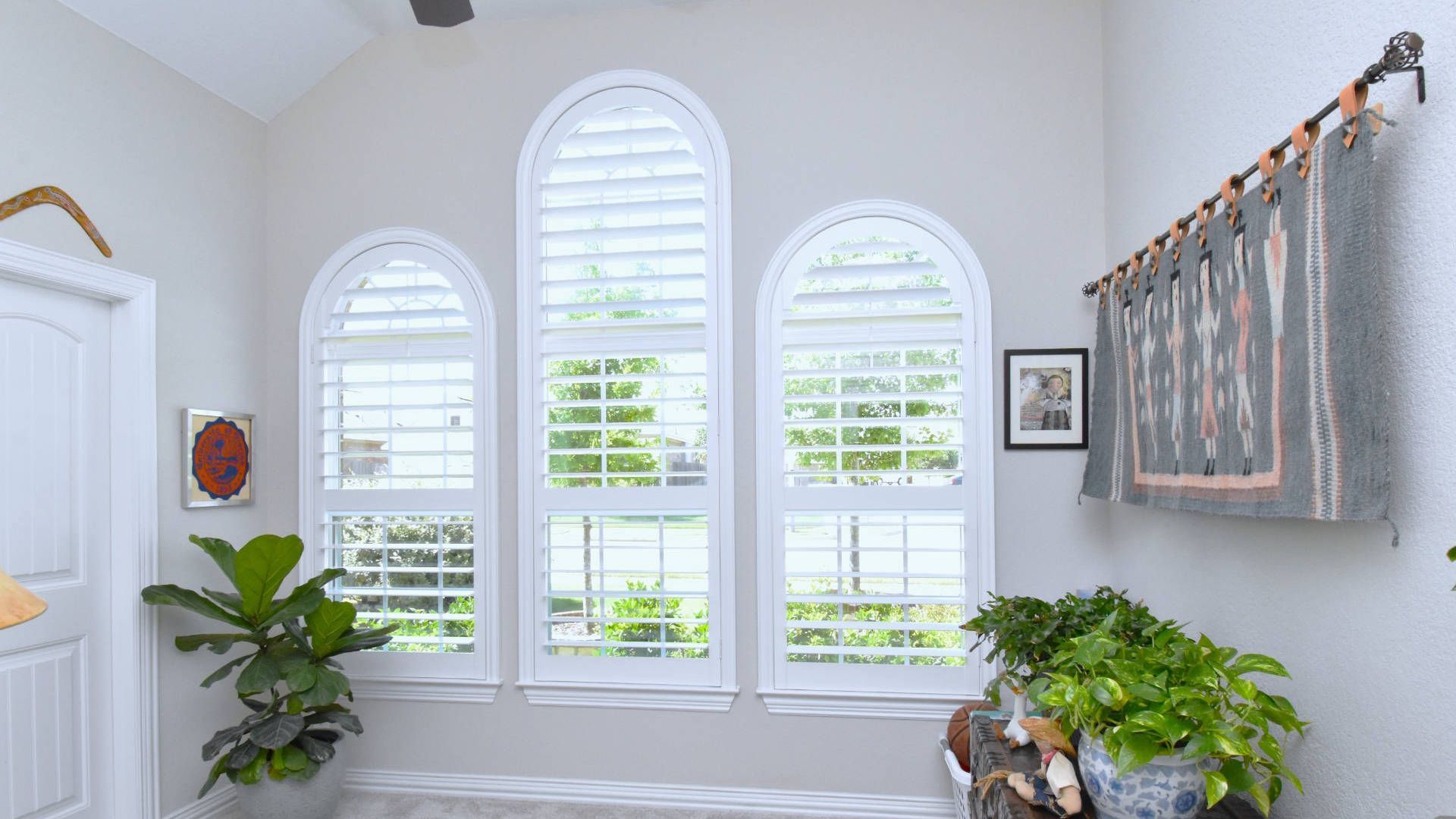 Airy Round Rock Home With Hidden Tilt Plantation Shutters Covering Arched Windows