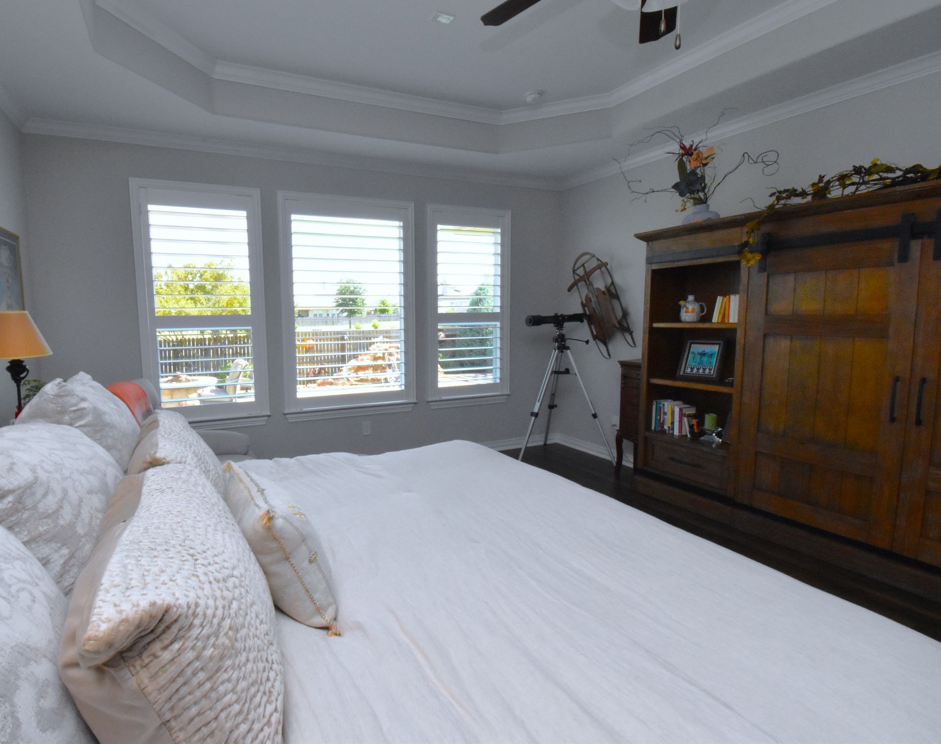 Simple white shutters in minimalist bedroom in Austin home