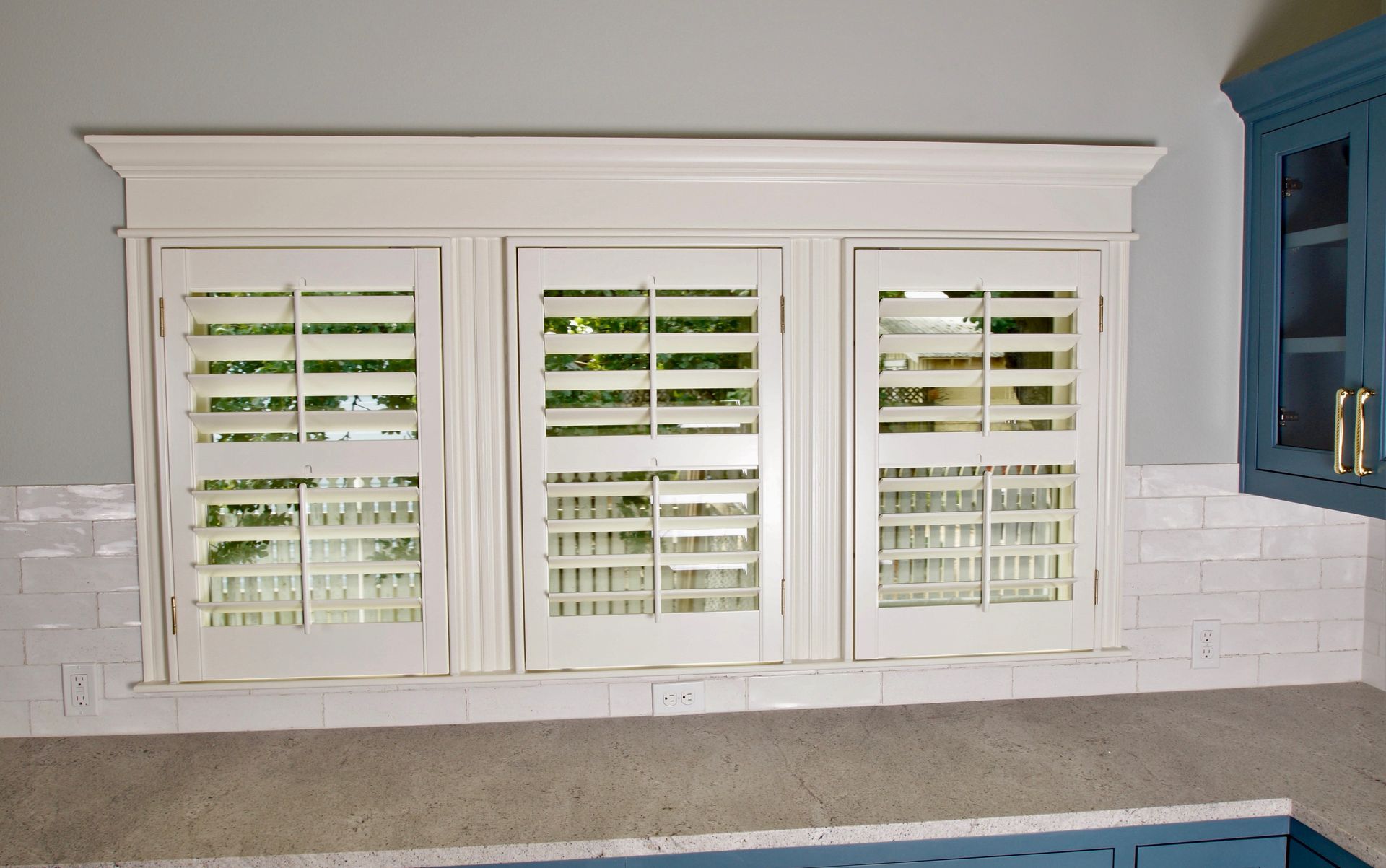 Cafe style plantation shutters in kitchen of Dripping Springs home 
