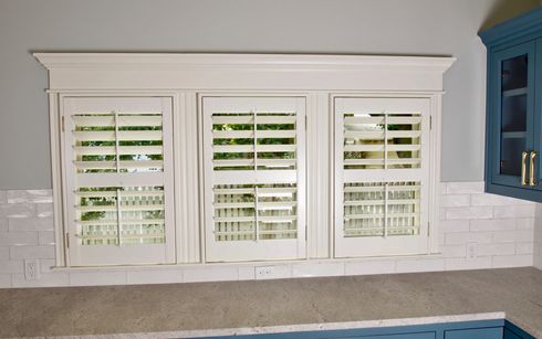 Cafe style plantation shutters in kitchen of Dripping Springs home 
