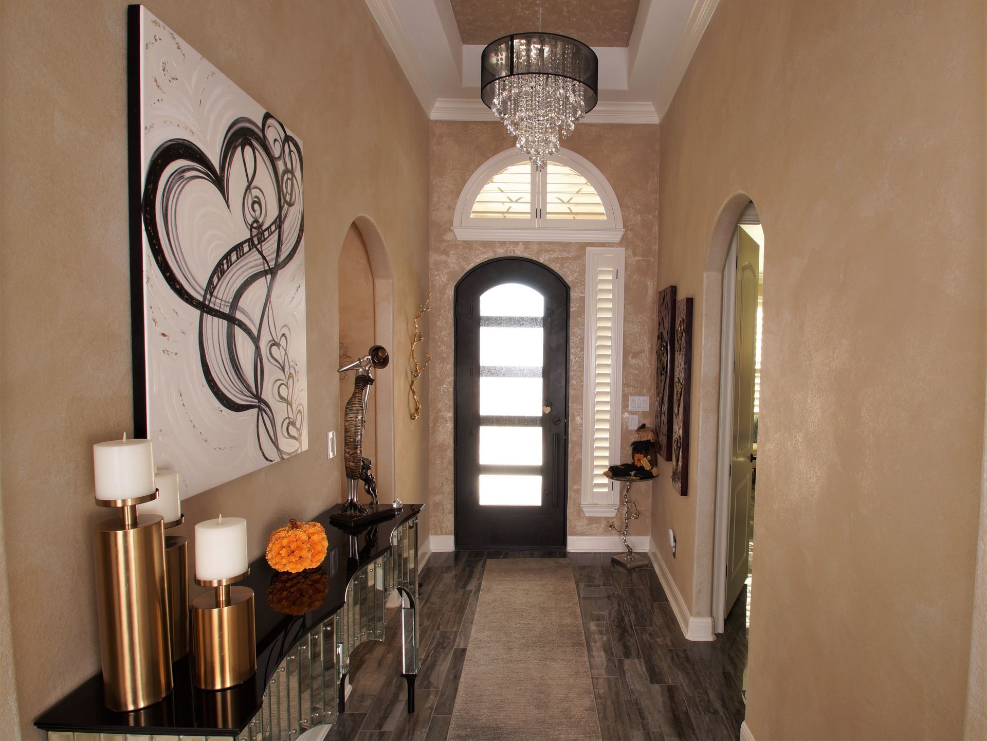 A hallway with candles and a painting on the wall