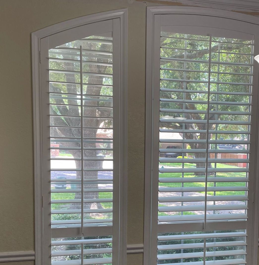 West lake hallway features arched plantation shutters over doors