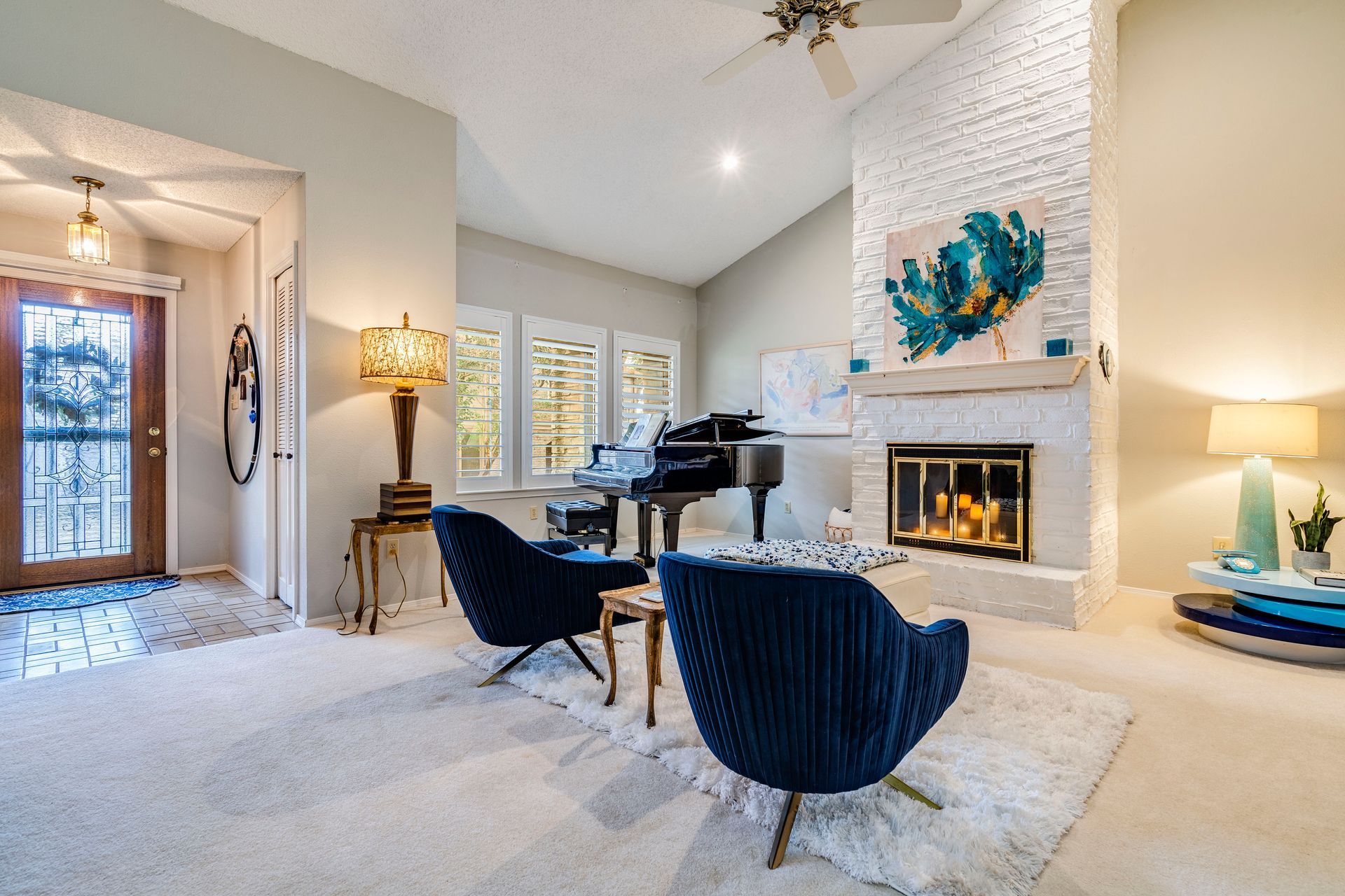 Luxurious white plantation shutters in elegant blue living room in Buda, Texas