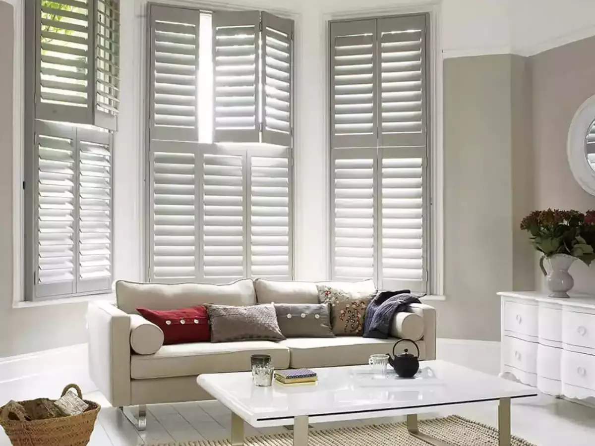 West lake hallway features arched plantation shutters over doors