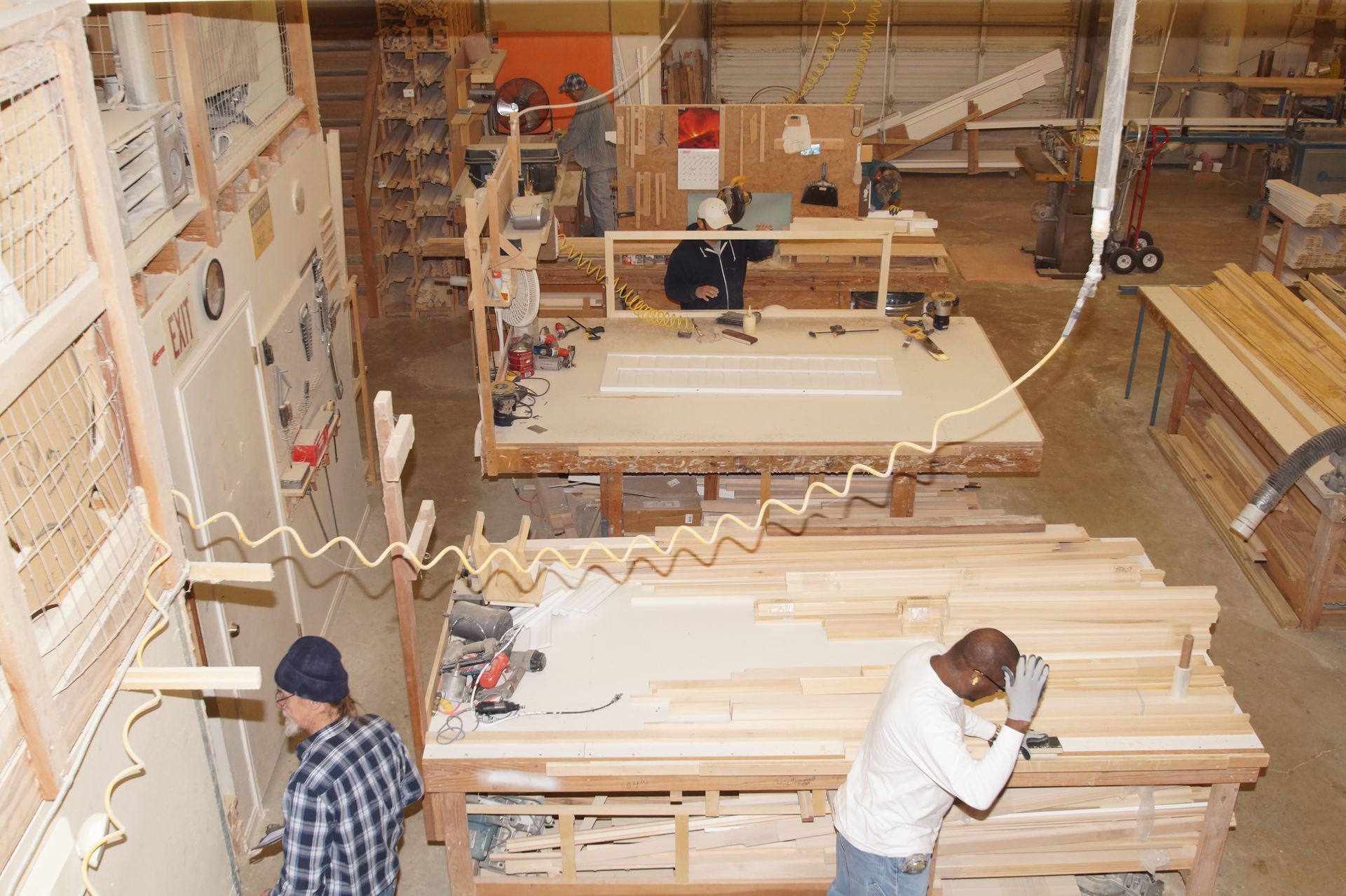 A man is working on a piece of wood in a factory