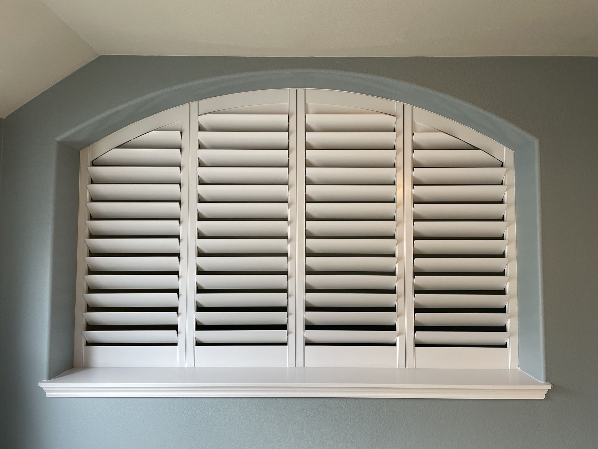 Arched window plantation shutters made from custom wood
