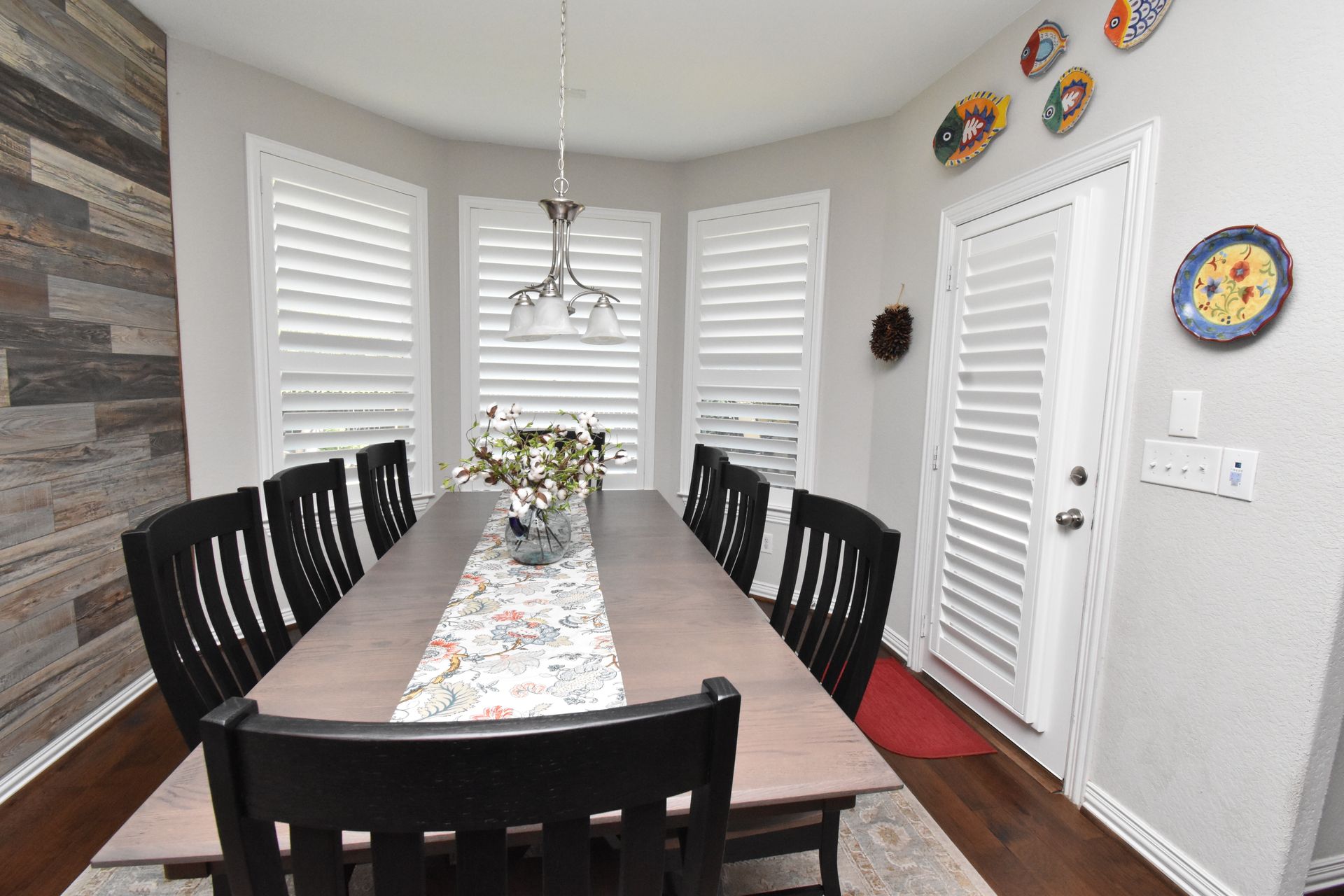 Classic white plantation shutters featured in a Austin, TX dining room