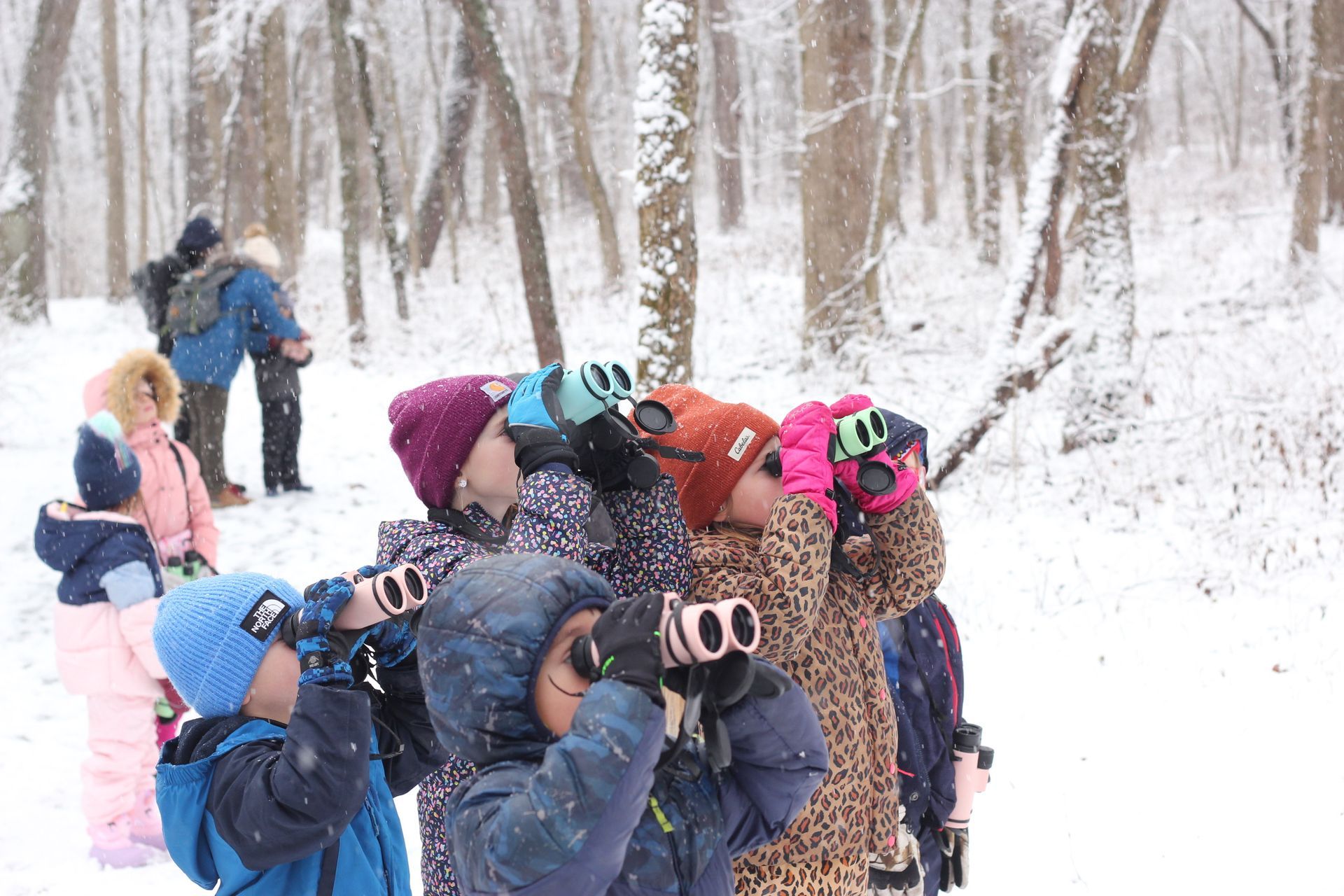 Young scientists using binoculars to look for birds.