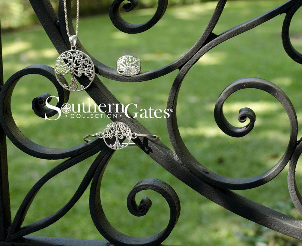 Wrought iron fence with silver pendant, bracelet, and ring
