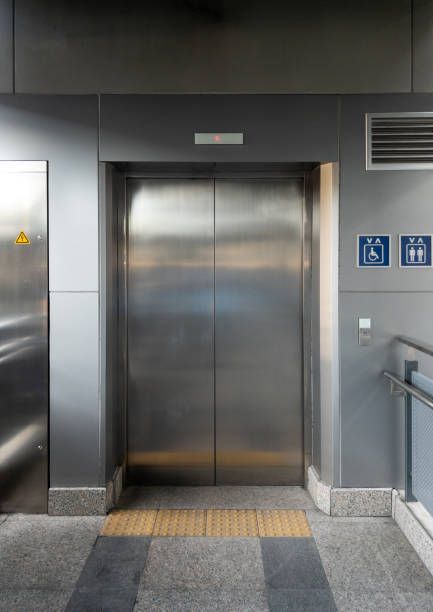 A stainless steel elevator door is open in a building.