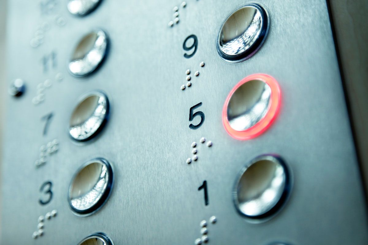 A close up of an elevator button with the number 5 on it