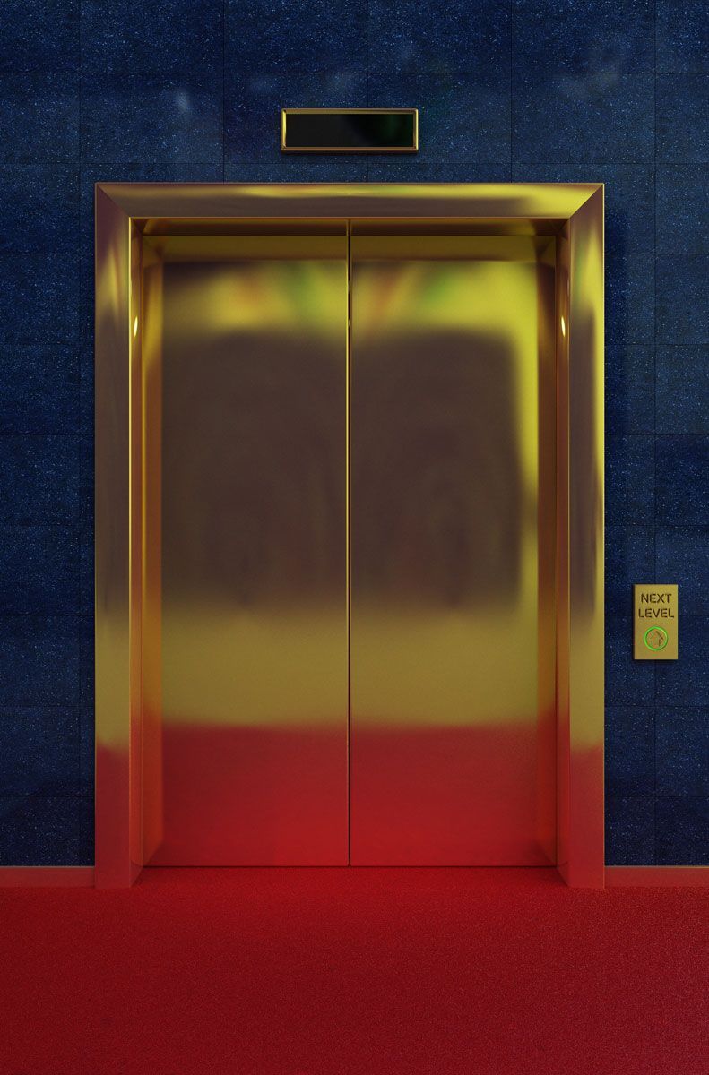 A gold elevator with a red carpet in front of it