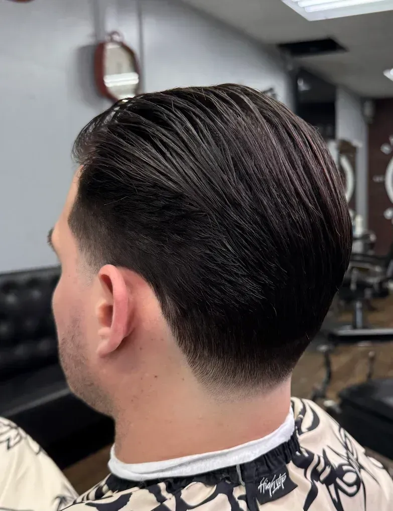 Barbershop counter with tools; brick wall background.