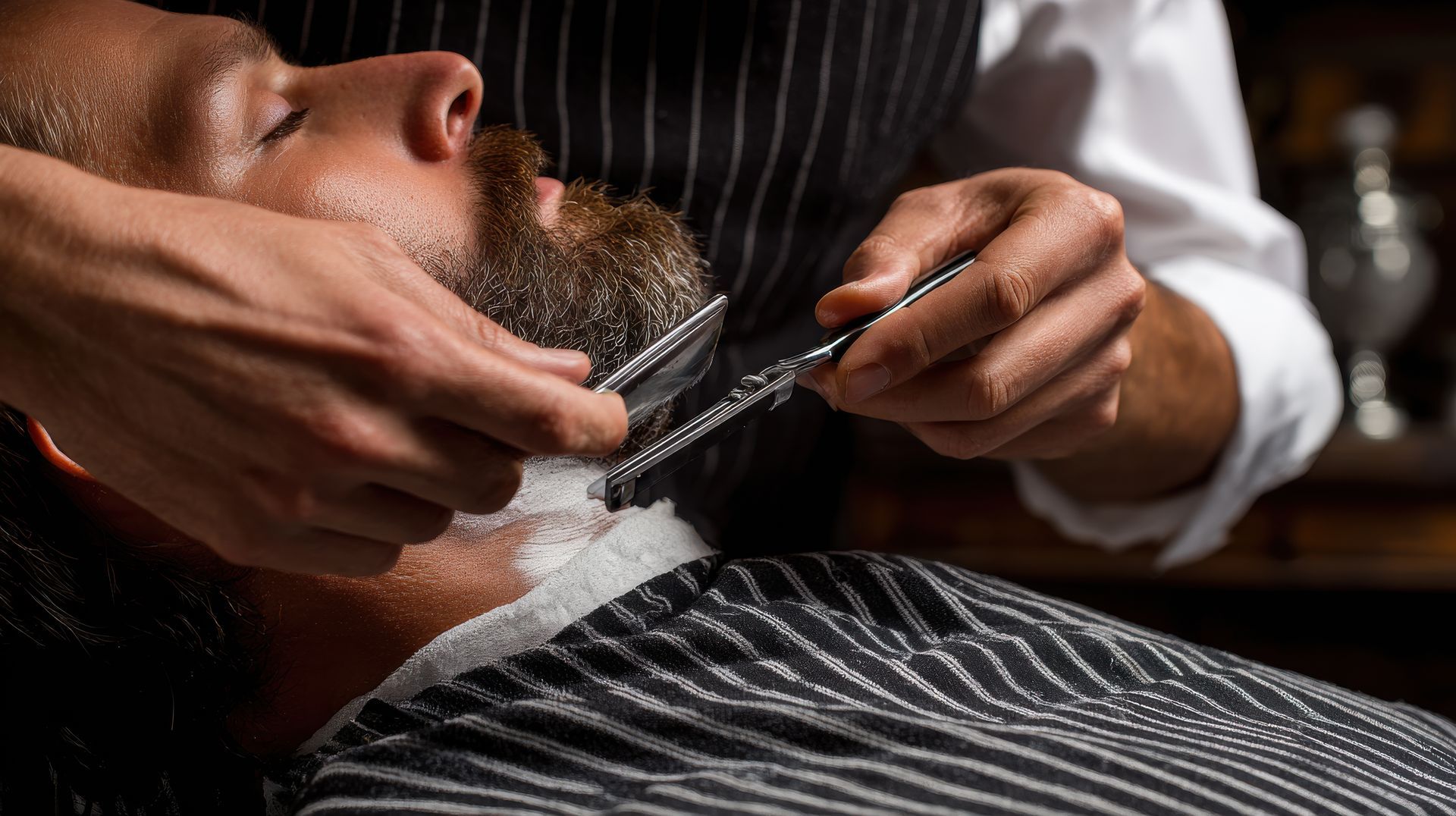 Man having shaving cream applied to his neck and jaw by a person in a white lab coat.